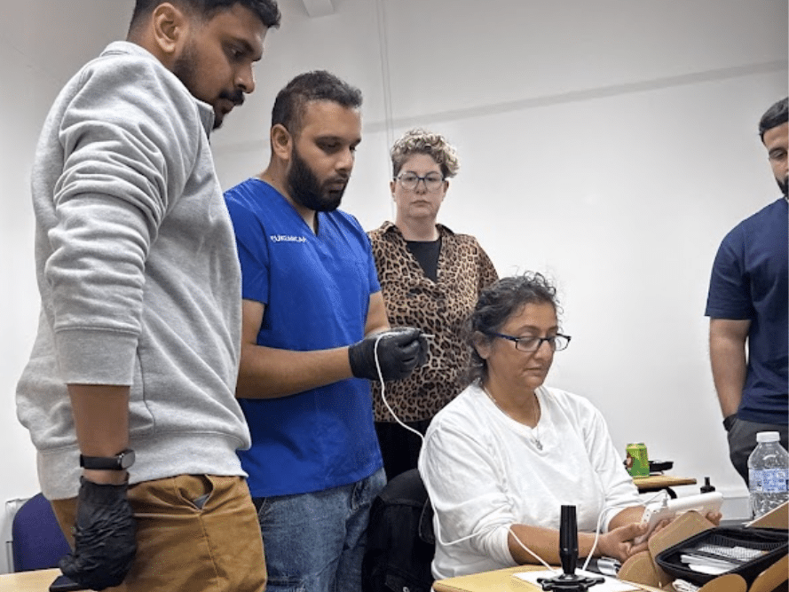 Group of trainees learning ear wax removal techniques