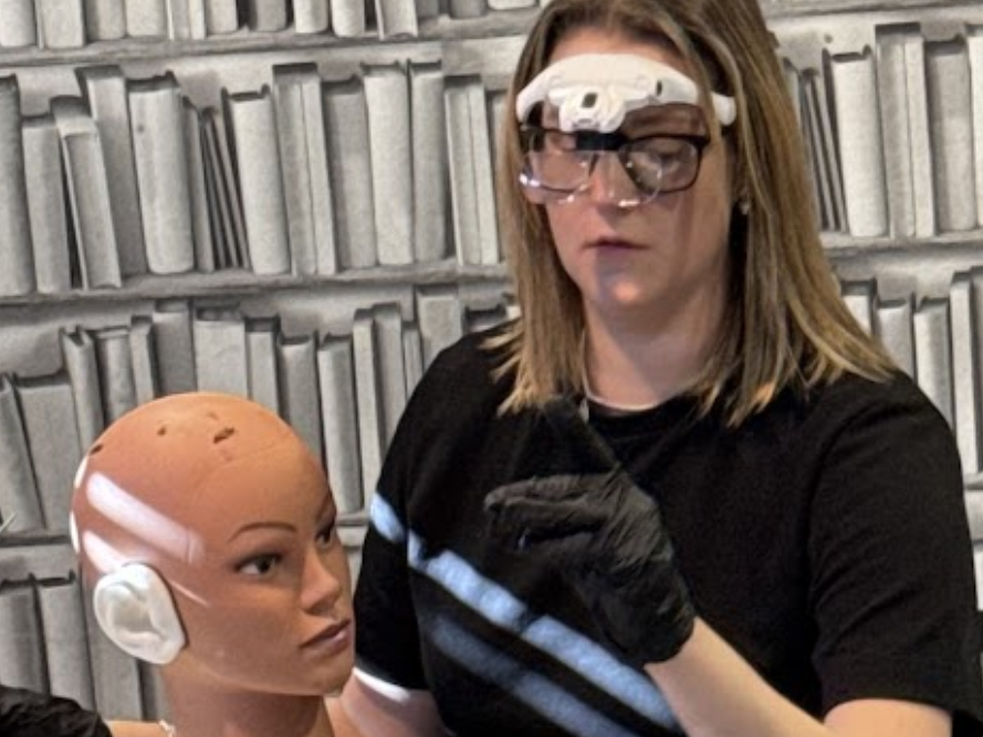 Trainee practising ear examination at workstation during course