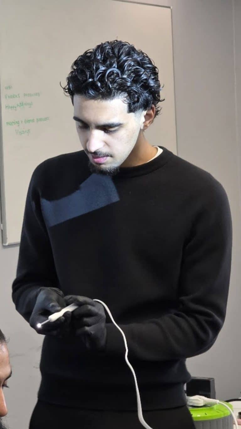 Trainer examining instrument during hands-on ear wax removal training